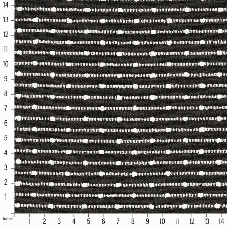 May include: Black and white fabric with a repeating pattern of small white circles in horizontal rows. The fabric is measured in inches.