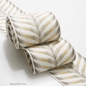 May include: Rolled-up decorative ribbon with a chevron pattern. The ribbon features alternating stripes of white, tan, and gray. The Etsy shop name "DesignNash.Etsy" is visible in the bottom left corner.
