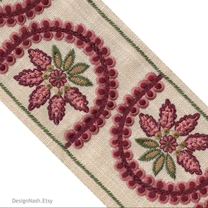 May include: Close-up of decorative trim with embroidered floral and circular patterns. The trim features a beige background with burgundy and pink floral designs, accented with green and burgundy trim.