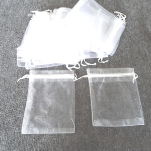 May include: A set of three ceramic mugs with a speckled, matte finish. The mugs are in shades of cream, light gray, and dark gray. Each mug has a simple, minimalist design, perfect for coffee or tea.