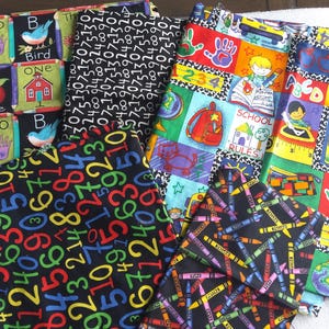 May include: Assortment of colorful fabric pieces with educational themes. Designs include numbers, letters, apples, birds, and school-related imagery like crayons, backpacks, and globes. The fabrics are likely for crafting or quilting.