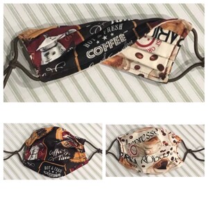 Puede incluir: Mascarillas de tela con diseños relacionados con el café y presillas ajustables para las orejas. Una mascarilla presenta el texto "HOT & FRESH COFFEE" sobre un fondo negro. Otra muestra granos de café y la palabra "espresso".