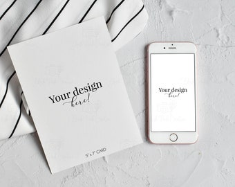 May include: A white card with the text "Your design here!" and "5 x 7 card" printed on it. A rose gold smartphone with a white screen displaying the text "Your design here!" is next to the card.