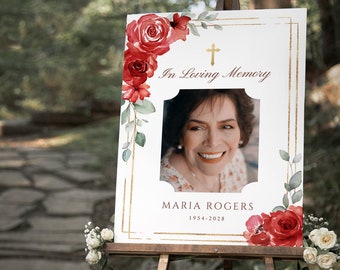 Puede incluir: Un cartel conmemorativo blanco con marco dorado y detalles florales rojos. El cartel dice "En memoria cariñosa" y presenta una foto de una mujer con el nombre "Maria Rogers" y las fechas "1954-2028".