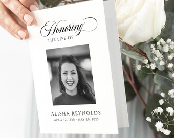 May include: A black and white photo memorial card with the text "Honoring The Life Of" and the name "Alisha Reynolds" with the dates "April 12, 1980 - May 20, 2025".