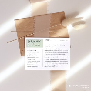 May include: A printable recipe card for Balsamic Dijon Chicken. The recipe card has a light green background with white text. The ingredients and directions are listed for a 2-serving recipe. The recipe card has a rustic, farmhouse aesthetic.