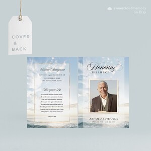 May include: A blue and white funeral announcement card with a photo of a man in a suit. The card has a gold border and the text "Honoring the Life of Arnold Reynolds April 12, 1970 - May 20, 2010".
