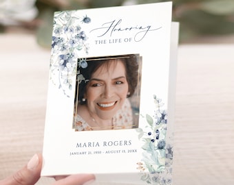 May include: A white memorial card with a blue and green watercolor floral design. The card features a gold frame with a photo of a woman smiling. The text "Honoring The Life Of Maria Rogers January 21, 1950 - August 15, 20XX" is printed on the card.