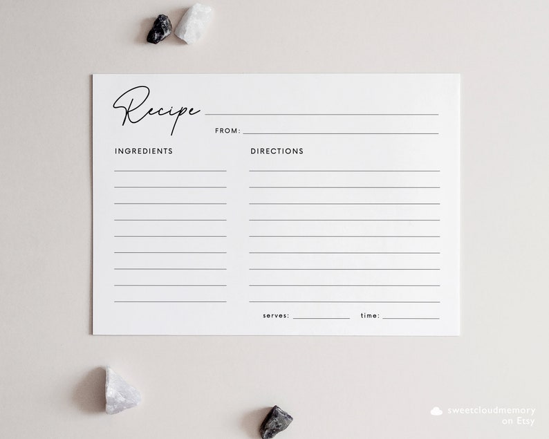 May include: A blank white recipe card with the word "Recipe" written in cursive at the top. The card is divided into two sections, one for ingredients and one for directions. There are lines for writing down the recipe. The card also has spaces for the name of the recipe, the number of servings, and the cooking time.