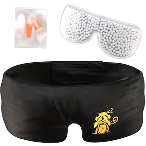 May include: A black sleep mask with a gold embroidered monkey design and the word "zzz" above it. The mask is accompanied by a clear plastic bag containing a pair of orange earplugs and a clear plastic eye mask filled with white beads.