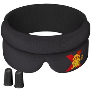 May include: Black sleep mask with a red X and a yellow monkey logo. The mask is designed to block out light and comes with two black earplugs.