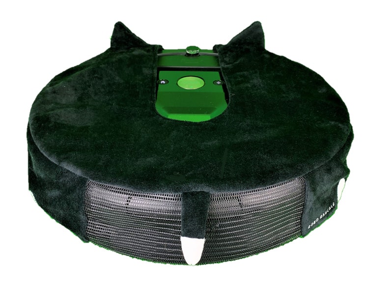 May include: A green robotic lawnmower with a black protective cover. The cover has a mesh bottom and a plush top with a cat-like design.
