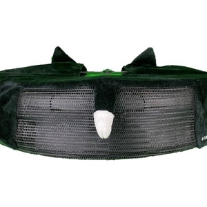 May include: Black and green trampoline with a white padded safety net and a white padded handle. The trampoline has the text "ROBO RASCALS" printed on the side.