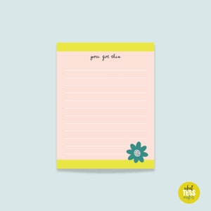 May include: A pink notepad with yellow borders and lined paper. The notepad has the text "you got this" written on it and a green flower illustration in the bottom right corner.