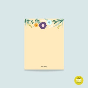 May include: A yellow notecard with a floral border of green leaves, purple, blue, and yellow flowers. The text "Mama Bear" is written at the bottom of the card.