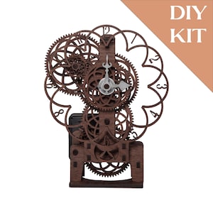 May include: A brown wooden DIY clock kit with intricate gear designs and a silver clock face. The clock features a decorative floral-shaped frame with numbers. The words "DIY KIT" are in the upper right corner.