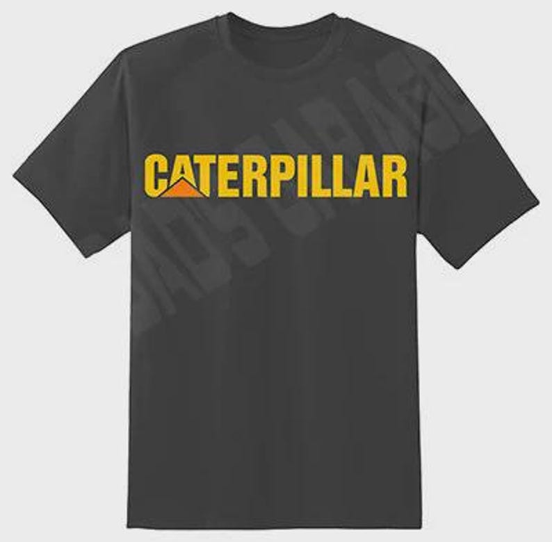 May include: Dark gray t-shirt featuring the word "CATERPILLAR" in yellow block letters with a yellow and orange logo. The shirt has short sleeves and a crew neck.