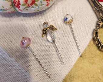 Angle Pin, pink floral pin and blue floral pin with gold accents