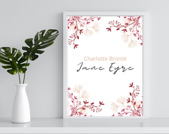 May include: A white framed print with a floral design in shades of red and beige. The text "Charlotte Brontë Jane Eyre" is centered on the print.