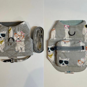 May include: Two gray quilted dog harnesses with a white dog print. One harness has a small pocket with a zipper. Both harnesses have a black strap with a metal clip.