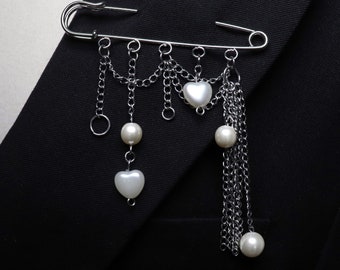 Brooch with chains and pearly heart shaped beads