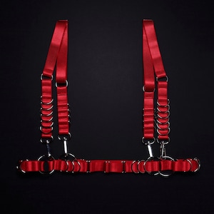 Satin elastic underbust harness decorated with D rings and carabiners.