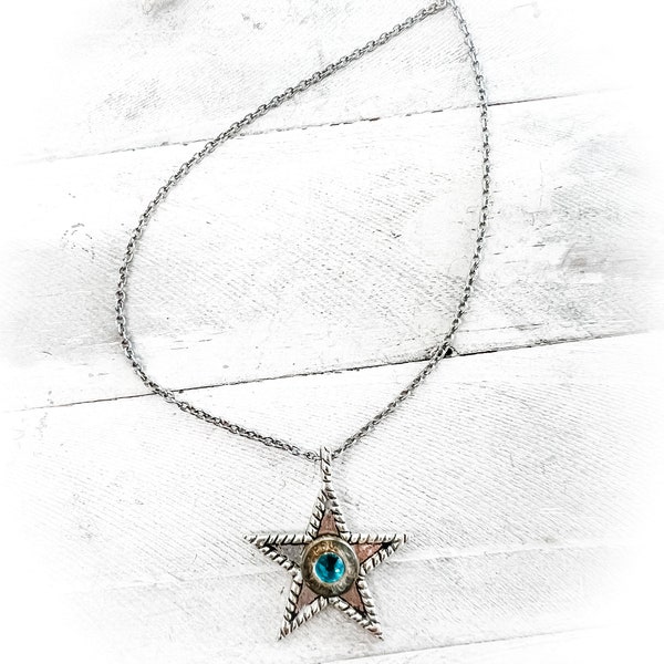 Western Star Choker necklace with a 9mm Bullet in the center and a Turquoise crystal. Simple elegance with an edge!