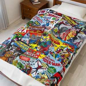 May include: A colorful comic book-themed blanket featuring various superhero comic book covers. The blanket showcases vibrant illustrations of characters like Spider-Man, Hulk, and Captain America, with text like "Avengers" and "Fantastic Four".