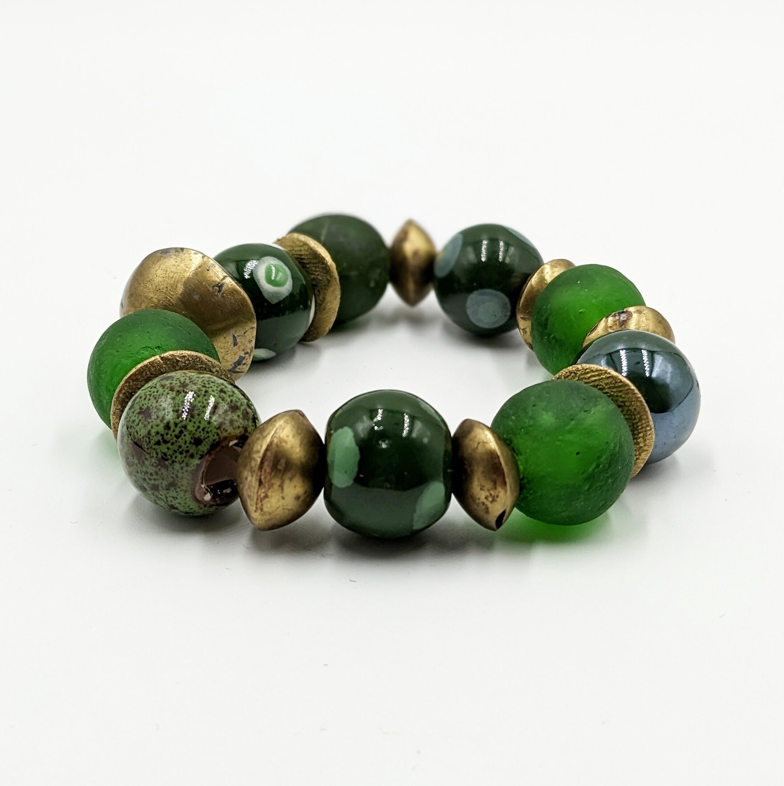 Green ethnic bracelet made of recycled glass, various ceramic beads, Tuareg gold and bronze discs. African beads. Ghana beads