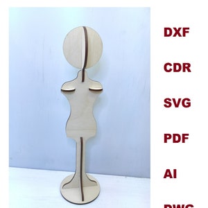 May include: A wooden mannequin with a round head and a stand. The mannequin is made of light wood and has a natural finish.
