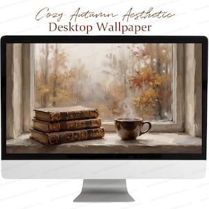 May include: A desktop computer monitor displaying a digital wallpaper of a stack of three leather-bound books and a steaming brown mug on a windowsill, with a view of autumn trees outside. The text Cozy Autumn Aesthetic Desktop Wallpaper appears.