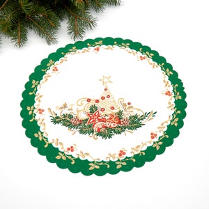 May include: A green and gold Christmas table runner with a white center featuring a stylized Christmas tree and ornaments.