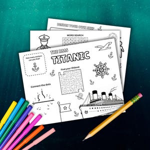 May include: A stack of white activity sheets with the text "THE RMS TITANIC" and various games, including a word search and a maze. A yellow pencil and a set of colorful markers are on the table.