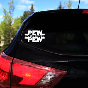May include: A black car with a white vinyl sticker on the rear window that says "PEW PEW PEW PEW PEW".