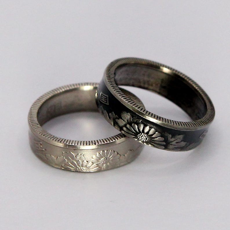 Our 50 yen ring is 5.5mm wide, made from real circulated 50 yen coins. The ring displayed on the right is our antiqued option, and the ring displayed on the left is our polished version.
