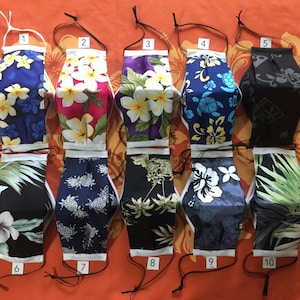 May include: Ten different patterned face masks with white trim and black elastic straps. The masks are numbered 1 through 10.