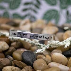 Hand Stamped Aluminum Cuff Bracelet: Just Keep Swimming Quote