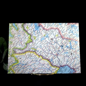 May include: A vintage map of the northeastern United States, showing the states of Maine, New Hampshire, Vermont, Massachusetts, Rhode Island, Connecticut, New York, New Jersey, Pennsylvania, and Delaware. The map is printed in blue, green, yellow, and red, and includes rivers, lakes, and cities.