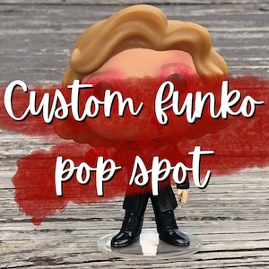 Könnte beinhalten: Eine benutzerdefinierte Funko Pop Figur mit einem rot-weiß-schwarzen Outfit. Die Figur hat blonde Haare und steht auf einem durchsichtigen Plastiksockel. Der Text "Custom Funko Pop Spot" ist in weiß auf rotem Hintergrund geschrieben.