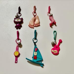 Vintage 80’s Retro Plastic Charms Bare Feet, Roller Skate, Pink Watch, Windsurfer, Pink Guitar, Purple Googly Eyed Figure