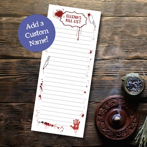 May include: A white notepad with the text "ELLENA'S KILL LIST" in a red, dripping font, with a knife illustration. The notepad has a lined interior and is decorated with red blood splatter and a handprint. A blue circle with the text "Add a Custom Name!" is in the upper left.