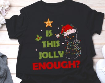 May include: Black t-shirt with a black cat wearing a Santa hat and Christmas lights. The text "Is this jolly enough?" is printed in green and red.