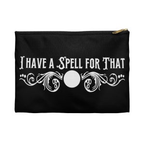 May include: Black zippered pouch with a white design that says "I have a spell for that" with a decorative flourish and a white circle in the center.