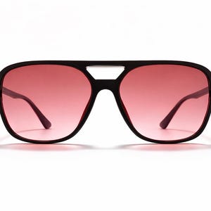 May include: A white ceramic mug with a black handle and the text "But First, Coffee" in a bold, black font. The mug is filled with a dark liquid, likely coffee, and sits on a light-colored surface.