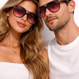 May include: A white ceramic mug with a black handle and the text "But First, Coffee" in a bold, black font. The mug is set against a blurred background, suggesting a cozy setting.