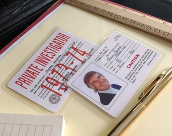 May include: A close-up of a plastic laminated private investigator identification card with the text "PRIVATE INVESTIGATOR" in red letters. The card has a photo of a man with brown hair and a light blue shirt. The text "RA 2174 (Individual) PRIVATE INVESTIGATOR" is printed on the card. The card also has the text "CAUTION" and a warning about the use of the card.