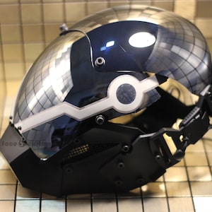 May include: A black and silver helmet with a mirrored visor and a white light strip. The helmet has a black face mask with a mesh grille.