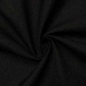 May include: Black fabric with a smooth, slightly textured surface. The fabric is folded and draped, showing its soft and drapey texture.