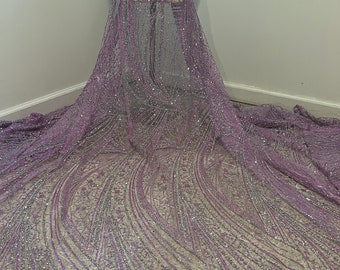 May include: Purple and silver glitter fabric with a wavy pattern. The fabric is sheer and has a delicate texture.