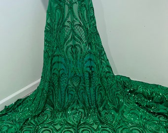 May include: Green sequined fabric with a floral pattern. The fabric is sheer and has a delicate, flowing texture.